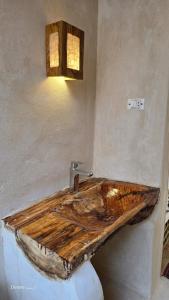 a bathroom with a wooden sink in the wall at Hidden Garden House in Siwa +123 photos