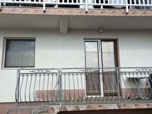 a balcony with a metal railing on a building at Apartman Buric in Vogošća