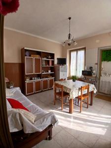 a living room with a table and a kitchen at Casa La V G in Almese