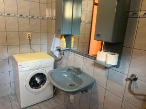 a bathroom with a washing machine and a washer at Apartman Buric in Vogošća