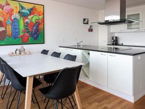 a kitchen with a white table and chairs at 5 star holiday home in Hadsund in Øster Hurup