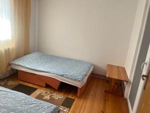 a small room with two beds and a table at Apartman Buric in Vogošća