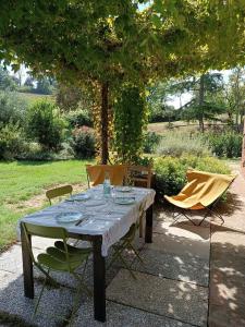 a table and two chairs sitting under a tree at Casa Quadrilumi B&B in Imola +12 photos