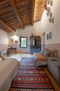 a bedroom with a bed and a couch and a table at Casa Quadrilumi B&B in Imola