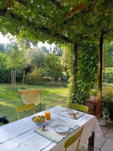 a table with a plate of food on top of it at Casa Quadrilumi B&B in Imola