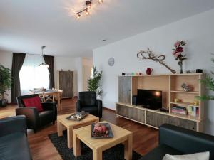 a living room with a couch and a tv at Serene Villa in Medebach K stelberg near Lake in Medebach