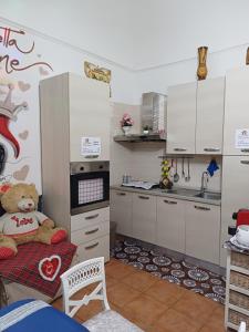 a kitchen with a teddy bear sitting on a table at la casetta di ciacione piazza del plebiscito in Naples