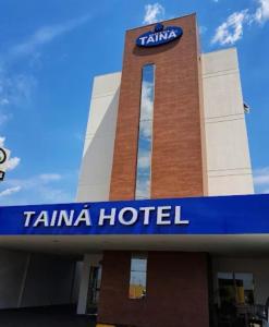 a tiana hotel with a sign on top of it at Hotel Tainá - Aeroporto Cuiabá in Várzea Grande
