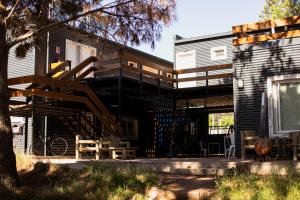 a house with a wooden staircase in front of it at Diez Pinos in Punta del Este