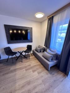 a living room with a couch and a table at Alpin Studio Haus, Kaibling & Ski amadé in Haus im Ennstal