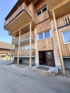 a building with wooden balconies on the side of it at Alpin Studio Haus, Kaibling & Ski amadé in Haus im Ennstal