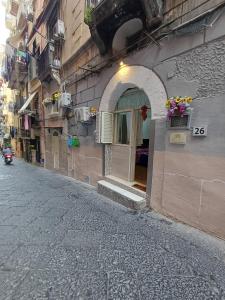 a building with a door on the side of a street at la casetta di ciacione piazza del plebiscito in Naples