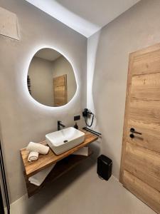 a bathroom with a sink and a mirror at Alpin Studio Haus, Kaibling & Ski amadé in Haus im Ennstal +33 photos