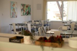 an empty room with tables and chairs and a window at Diez Pinos in Punta del Este