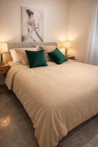 a large bed with green pillows in a bedroom at La Chic Opéra - à 30 secondes min du Vieux-Port- Clim in Marseille