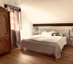 a bedroom with a large white bed and a window at undfein boutique studios in Sankt Gilgen