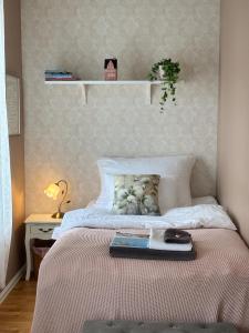 a bedroom with a bed with a book on it at Fruenes in Volda
