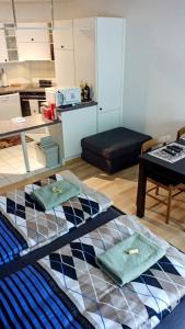 a living room with a bed and a kitchen at Central 2, nice two room apartment, free bus, city tax included in Lucerne
