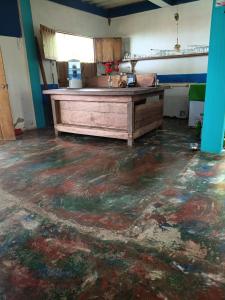 a kitchen with a wooden counter in a room at Casa hostal playa coral in Capurganá