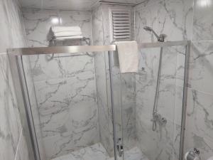 a shower with a glass door in a bathroom at The Montana City Hotel in Bostaniçi +9 photos
