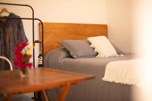 a bed with a wooden headboard with a pillow on it at Diez Pinos in Punta del Este