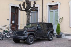 a black jeep parked in front of a house at Haven Loft Como - Private Spa, Parking & Jacuzzi in Como