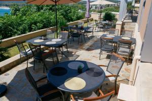 a row of tables and chairs with umbrellas on a patio at Solinaria Boutique Hotel in Sozopol +39 photos