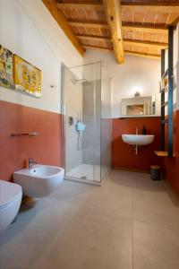 a bathroom with a glass shower and a sink at Casa Quadrilumi B&B in Imola