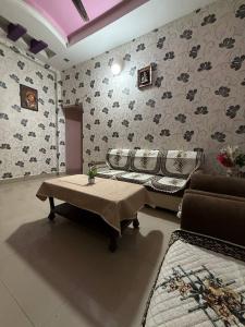 a living room with a couch and a coffee table at Karuna Homestay in Ujjain