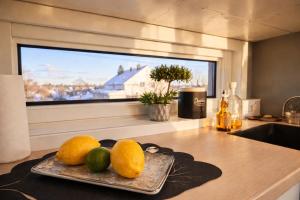 a plate of fruit on a kitchen counter with a window at KB - Nordic Lux Villa in Sørvågen +50 photos