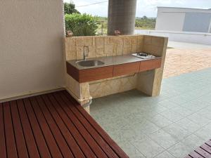 a kitchen counter with a sink in a patio at Cottage Tasuki in Nakijin +43 photos