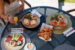 a woman sitting at a table with plates of food at Solinaria Boutique Hotel in Sozopol