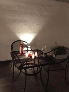 a table with a bottle of wine and candles on it at Hotel Miranda Querétaro in Querétaro