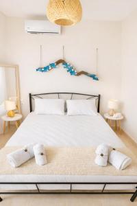 a bedroom with a bed with towels on it at Haroupia The Residence in Kalidhón