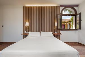 a large white bed in a room with a mirror at Cerro de Hijar in Tolox +57 photos
