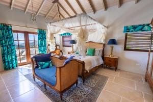 a bedroom with a bed and two chairs at Tuckers Villa in Cobbs Cross +56 photos