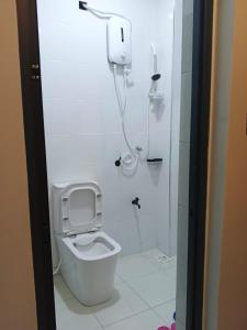 a bathroom with a toilet and a shower at Bluu Diani in Diani Beach