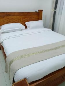 two beds sitting next to each other in a bedroom at Bluu Diani in Diani Beach +2 photos