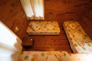 a room with three beds in a wooden room at Olympos Yakamoz Pansiyon in Olympos +53 photos