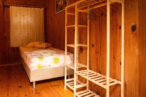a bedroom with a bunk bed and a wooden wall at Olympos Yakamoz Pansiyon in Olympos