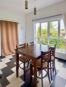 a dining room with a wooden table and chairs at Ensuite Room in a shared apartment with pool in Albion