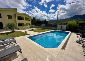 a swimming pool in the backyard of a house at Villa Piste - Skadar Lake in Virpazar