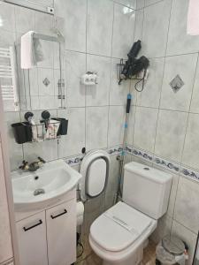 a small bathroom with a toilet and a sink at Cichy Zakątek in Bobolin +19 photos