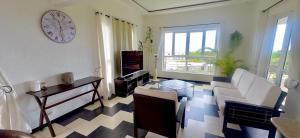 a living room with a couch and a table at Ensuite Room in a shared apartment with pool in Albion