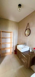 a bathroom with a sink and a mirror on the wall at Ensuite Room in a shared apartment with pool in Albion
