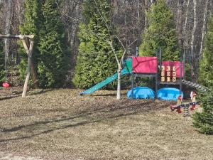 a playground with a slide and a play set at Cichy Zakątek in Bobolin