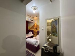 a small room with a bed and a bathroom at Jana Pyramids view inn in Cairo