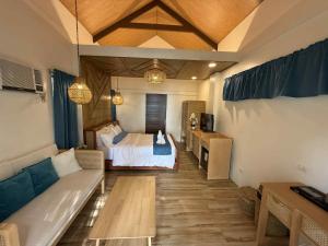 a bedroom with a bed and a couch in a room at Island Garden Beach Resort in Samal