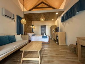a living room with a couch and a bed and a table at Island Garden Beach Resort in Samal +67 photos