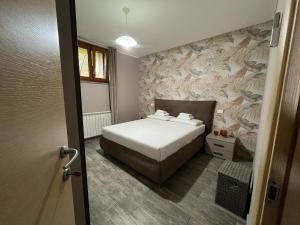 a bedroom with a bed and a wall at Casa del Duca Portoferraio in Portoferraio +25 photos